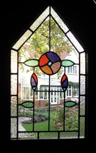 Stained glass in a thatched summer house